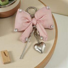 CIONDOLO FIOCCO CIPRIA CON STRASS E CUORE PER BOMBONIERE